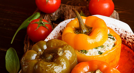 homemade, stuffed peppers. with a filling of basil, spinach, cheese and spices. with gravy from fresh home-made tomatoes. made in a rustic style.
