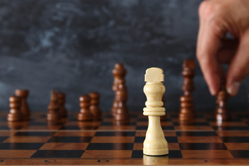 Image of businessman hand moving chess figure over chess board. Business, competition, strategy, leadership and success concept.
