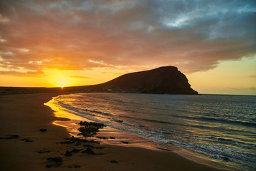 Fantastic sunset by the sea. Last rays of the setting sun on the ocean beach. Evening at the...