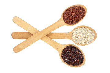 Black red white quinoa seeds in wooden spoon isolated on white background. Top view