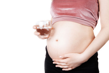 Pregnant woman holding glass of water