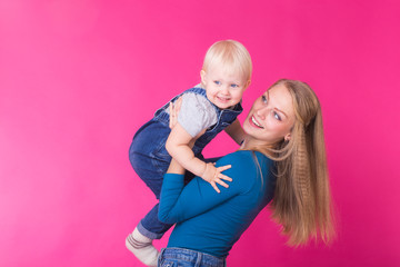 Funny family on pink background. Mother and her daughter girl. Mom and child are having fun.