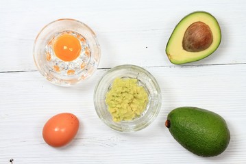 Facial or hair mask from avokado and egg / Alternative medicine concept, homemade mask from edible ingredient,