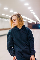 beautiful young blonde girl in an underpass