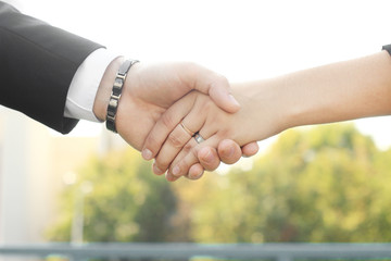 close up. the handshake business partners in the outdoors.photo with copy space.