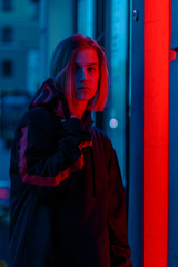portrait of a girl in red blue in the street