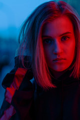 portrait of a girl in red blue in the street