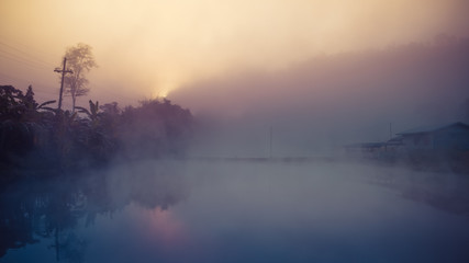 Fototapeta premium Cottage among mountain and fog