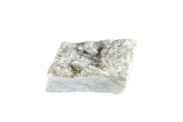 Macro shooting of natural gemstone. The raw mineral is talc. Italy. Isolated object on a white background.