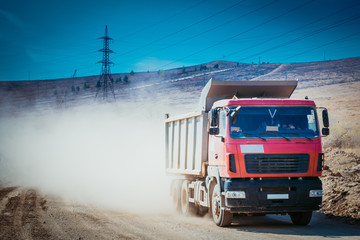 Mist of dust on the country road after big car passing.