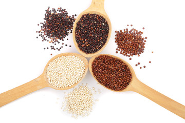 Black red white quinoa seeds in wooden spoon isolated on white background. Top view