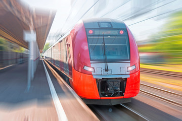 High-speed electric train with motion blur. Train at the railway station.