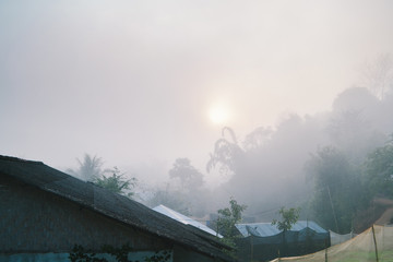village among mountain and fog