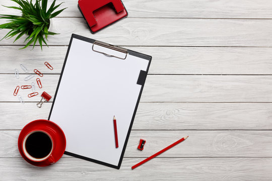 white table boards folders red notebook cup morning coffee clock paper clips keyboard mouse office worker office
