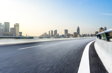 Fototapeta premium empty road with panoramic city skyline