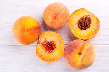 Fototapeta na wymiar Ripe peaches close-up on a white wooden background.