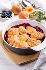 Freshly baked peach and blueberry cobbler. Homemade fruit pie.
