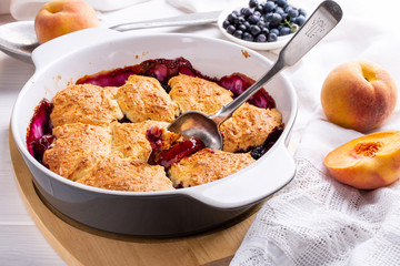 Freshly baked peach and blueberry cobbler. Homemade fruit pie.