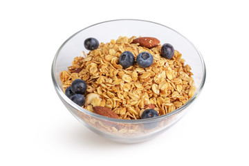 Bowl of homemade granola with fruit pieces isolated on white