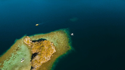 Aerial view: beach, tropical island, sea bay and lagoon, Palawan. Lagoon with blue, azure water in the middle of small islands and rocks. Busuanga. Seascape, tropical landscape. Philippines.