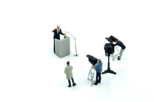 Miniature people : journalists , cameraman ,Videographer at work shooting of the campaign