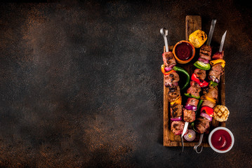 Fresh, home-cooked on the grill fire meat beef shish kebab with vegetables and spices, with...