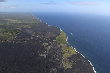 Fototapeta na wymiar Helicopter aerial view of lava field by the ocean, Big Island, Hawaii