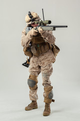 Soldier in camouflage holding rifle