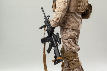 Soldier in camouflage holding rifle