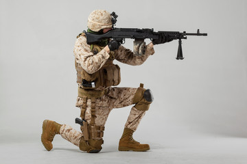 Soldier in camouflage holding rifle