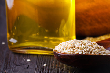 Sesame oil in glass and seeds