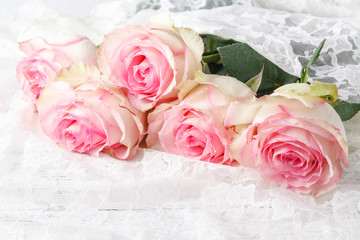 vintage group of pink roses on wooden table, soft focus