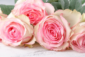 vintage group of pink roses on wooden table, soft focus