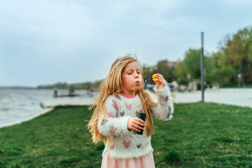 Little happy pretty girl have fun in the park