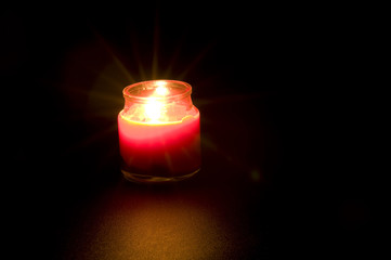 Red Candle against Dark Background