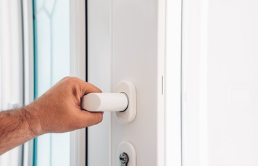 Naklejka premium front door. hand holds doorknob on front door PVC