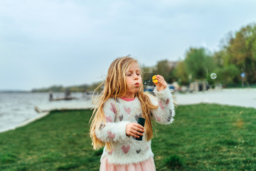 Little happy pretty girl have fun in the park