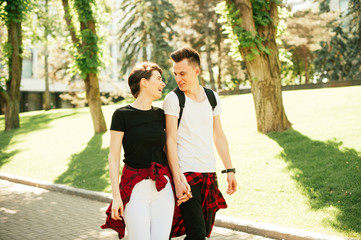 Beautiful young lovely couple walking outside in the city