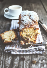 Freshly baked cake and a cup of coffee on the wooden table. Rustic style