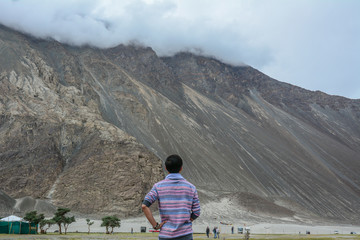 Young traveler looking at mountains