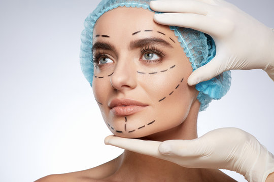 Beautiful girl in blue cap with puncture lines on face