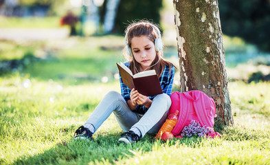 Schoolgirl reading a book. Education, lifestyle concept