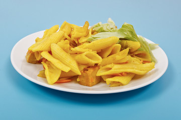 Baked pasta with curry on a blue