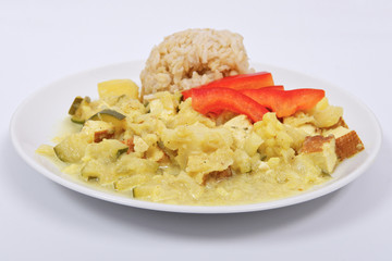 Cauliflower mixture with curry and rice on a white