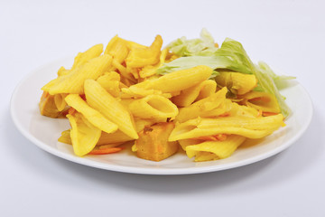 Baked pasta with curry on a white