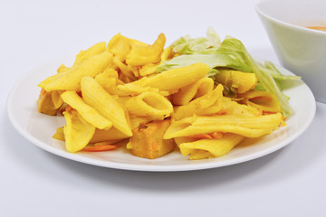 Baked pasta with curry on a white