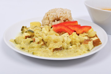 Cauliflower mixture with curry and rice on a white