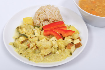 Cauliflower mixture with curry and rice on a white