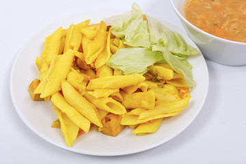 Baked pasta with curry on a white