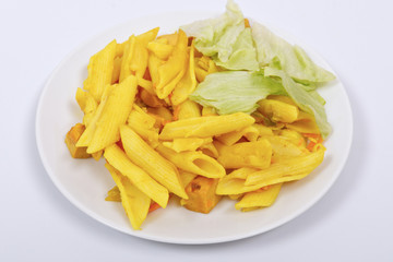 Baked pasta with curry on a white